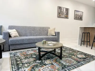 a living room with a couch and a coffee table at Easy-Access & Quick to NYC, EWR, Dream Mall, Stadium in Jersey City