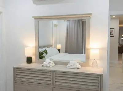 a bedroom with a mirror and a dresser with towels at Easy-Access & Quick to NYC, EWR, Dream Mall, Stadium in Jersey City
