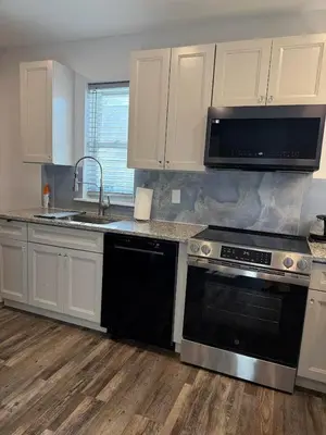a kitchen with a black stove and a sink at New house close to Fairmount Park in Philadelphia