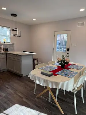 a kitchen with a table and a kitchen with a counter at New house close to Fairmount Park in Philadelphia