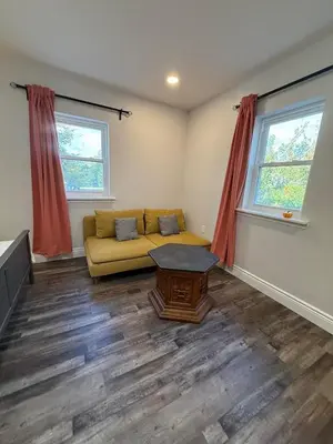 a living room with a couch and two windows at New house close to Fairmount Park in Philadelphia