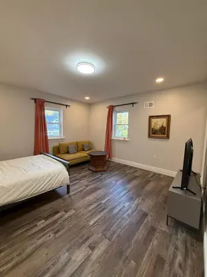 a bedroom with a bed and a couch and a tv at New house close to Fairmount Park in Philadelphia