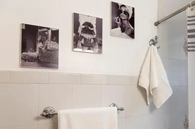 a bathroom with three pictures on the wall at Serene Hamilton ELM 13MI to Time Square Laundry Easy Parking in Teaneck