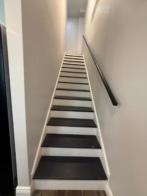 a stairway with black and white stairs in a building at Spacious private room in a new house with private bathroom close to center city in Philadelphia