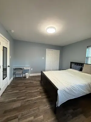 a bedroom with a large bed and a desk at Spacious private room in a new house with private bathroom close to center city in Philadelphia