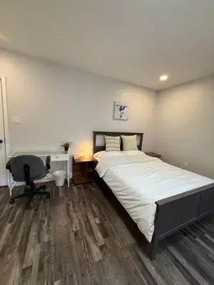 a bedroom with a bed and a desk and a chair at Spacious private room in a new house with private bathroom close to center city in Philadelphia