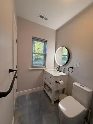 a bathroom with a sink and a toilet and a mirror at Spacious private room in a new house with private bathroom close to center city in Philadelphia
