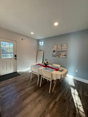 a living room with a table and a couch at Spacious private room in a new house with private bathroom close to center city in Philadelphia