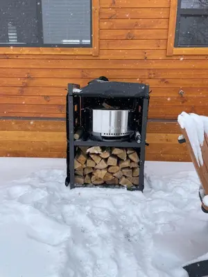 a stove with a pot on top of a pile of wood at Private Luxury Log Cabin in the Endless Mountains, Firepit, Farm Charm in Kingsley