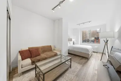 a living room with a couch and a bed at The Aurora in New York