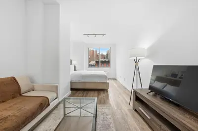 a living room with a couch and a tv at The Aurora in New York