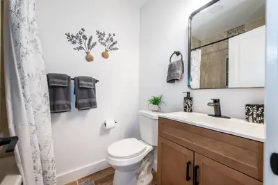 a bathroom with a toilet and a sink and a mirror at Apartment in Irvington Unit B in Irvington