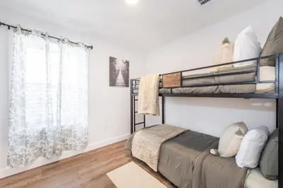 a bedroom with two bunk beds and a window at Apartment in Irvington Unit B in Irvington