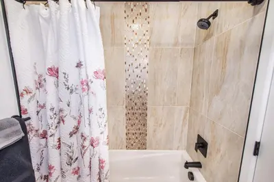 a bathroom with a shower curtain and a tub at Apartment in Irvington Unit B in Irvington