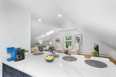 a kitchen and living room with a white counter top at Montclair's Best Stays in Montclair