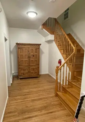 an empty hallway with stairs and a wooden door at Montclair's Best Stays in Montclair