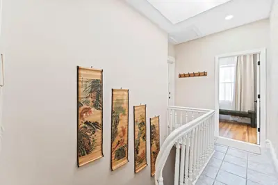 a hallway with four paintings on the wall at Casa Kanso in Jersey City