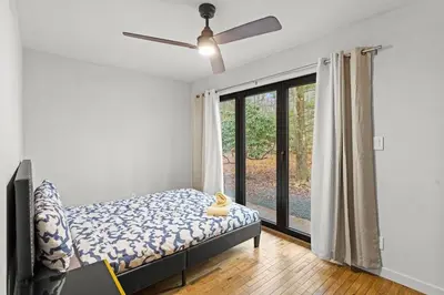 a bedroom with a bed and a large window at Pine Breeze in Pocono Pines