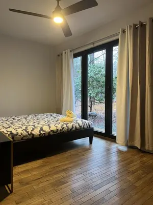 a bedroom with a bed and a large window at Pine Breeze in Pocono Pines