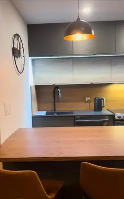 a kitchen with a wooden table and aendant light at Pine Breeze in Pocono Pines
