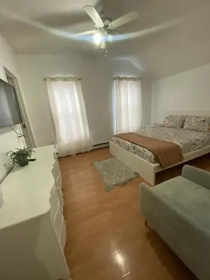 a bedroom with a bed and a ceiling fan at Spacious Private Room with Private Bath in Paterson