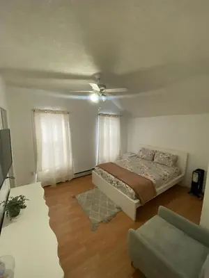 a bedroom with a bed and a ceiling fan at Spacious Private Room with Private Bath in Paterson
