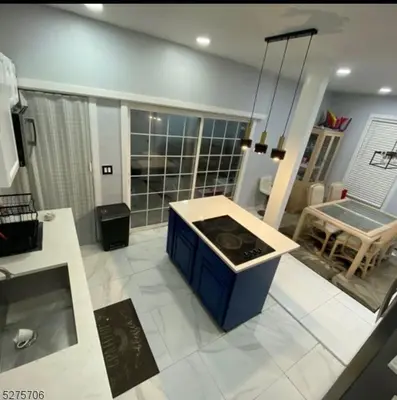 a kitchen with a stove in the middle of a room at Spacious Private Room with Private Bath in Paterson