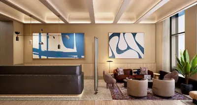 a lobby with a waiting area with chairs and a couch at Kimpton Era Midtown New York by IHG in New York
