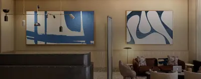 a living room with blue and white paintings on the wall at Kimpton Era Midtown New York by IHG in New York