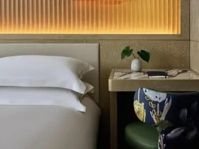 a bedroom with a bed and a table with a plant on it at Kimpton Era Midtown New York by IHG in New York