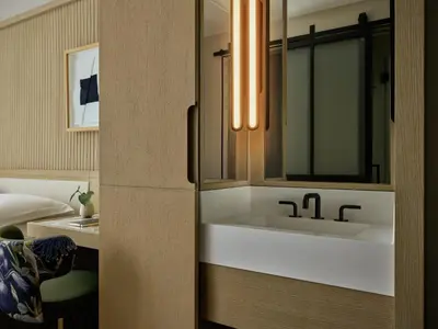 a bathroom with a sink and a mirror at Kimpton Era Midtown New York by IHG in New York