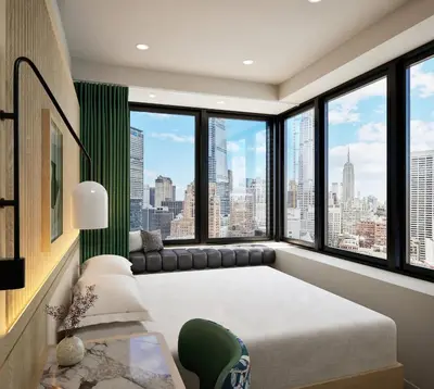 a bedroom with a large bed and large windows at Kimpton Era Midtown New York by IHG in New York