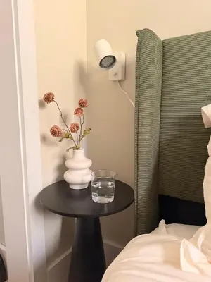 a table with a glass of water and a vase on it at Modern 3-Bedroom Retreat with Fire Pit - Ski at Big Bear - Mountain Views in Eldred