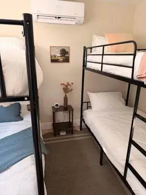 a dorm room with two bunk beds and a window at Modern 3-Bedroom Retreat with Fire Pit - Ski at Big Bear - Mountain Views in Eldred