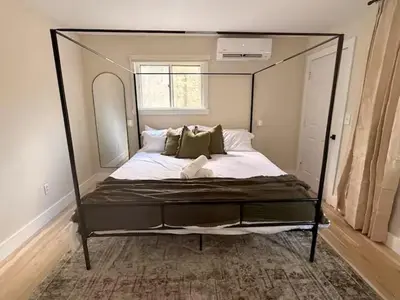 a bedroom with a canopy bed in a room at Modern 3-Bedroom Retreat with Fire Pit - Ski at Big Bear - Mountain Views in Eldred