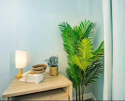 a table with a lamp and plants on it at Sky-view 2BD Apartment In Northern Liberties in Philadelphia