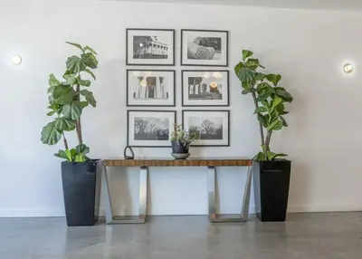 a table with two potted plants on a wall at Sky-view 2BD Apartment In Northern Liberties in Philadelphia