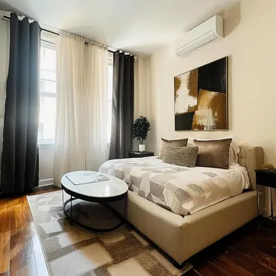 a bedroom with a bed and a table in it at The Helton Suites at Midtown in New York