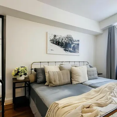 a bedroom with a bed with pillows on it at The Helton Suites at Midtown in New York