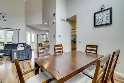 a dining room and living room with a table and chairs at Hot Tub and Epic Game Room! Poconos Family Retreat in Blakeslee