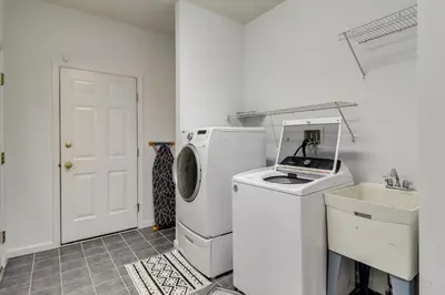 a laundry room with a washing machine and a sink at Hot Tub and Epic Game Room! Poconos Family Retreat in Blakeslee