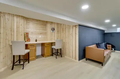 a living room with a couch and a table and chairs at Hot Tub and Epic Game Room! Poconos Family Retreat in Blakeslee