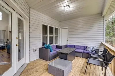 a porch with a purple couch and a table at Hot Tub and Epic Game Room! Poconos Family Retreat in Blakeslee