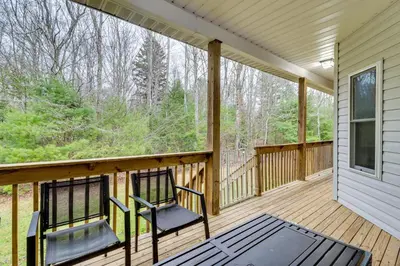 a screened porch with two chairs on it at Hot Tub and Epic Game Room! Poconos Family Retreat in Blakeslee