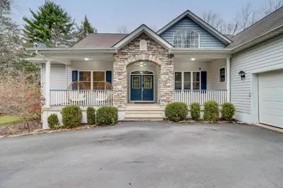 a house with a blue door and a driveway at Hot Tub and Epic Game Room! Poconos Family Retreat in Blakeslee