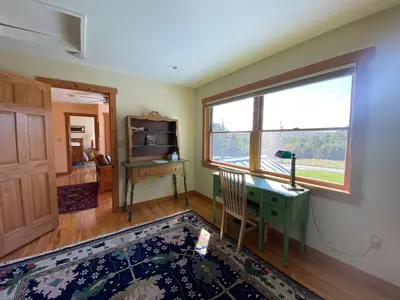 a room with a desk and a window at Apple Orchard & Forest Retreat with Woodland Pond in Forestburgh