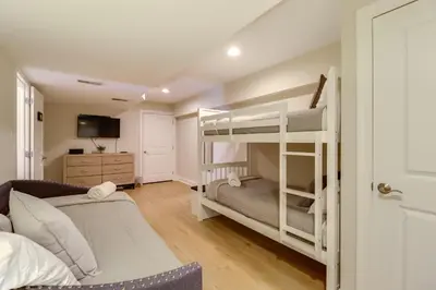 a bedroom with a bunk bed and a couch at Walk to Big Boulder Mtn and Lake, Home with Hot Tub! in Lake Harmony