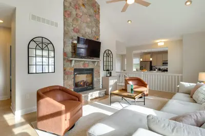 a living room with a couch and a fireplace at Walk to Big Boulder Mtn and Lake, Home with Hot Tub! in Lake Harmony
