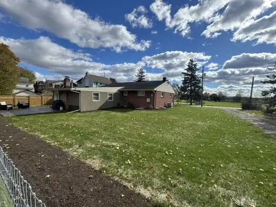 a house with a yard with a fence at Farm Views - 10 min to Sight & Sound in Ronks