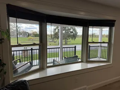 a room with a window with chairs on a balcony at Farm Views - 10 min to Sight & Sound in Ronks
